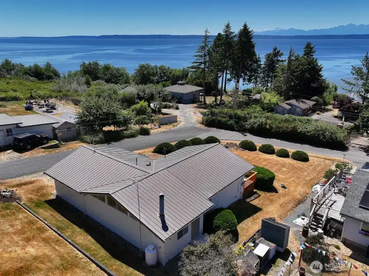 Metal roof and plenty of yard space. Enjoy stunning sunsets and ship action through Admiralty's Inlet.