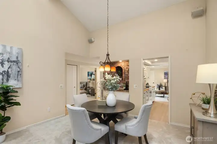 The spacious dining room connects seamlessly to the kitchen and includes a wet bar with a brick surround.