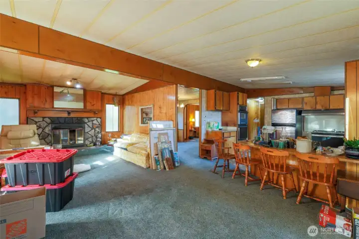 Open floor plan wood burning fireplace in family room.