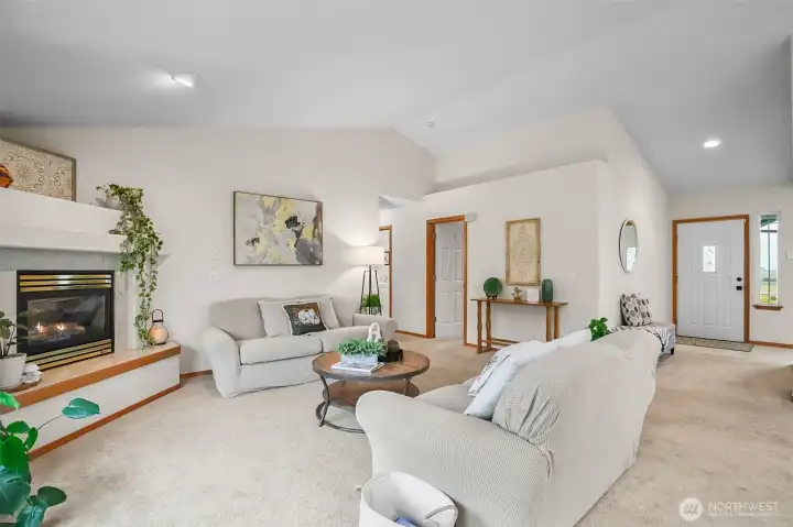 Family room with corner propane fireplace.