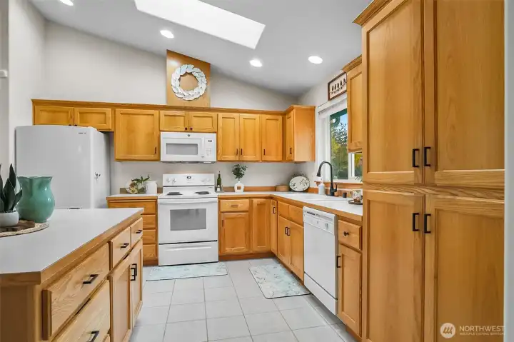 Kitchen with vaulted ceilings, skylight and plenty of storage.