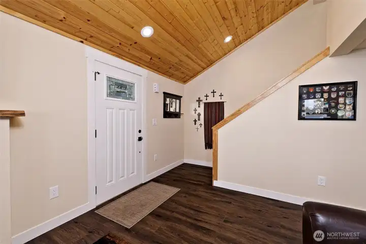 Main entry and stairway to loft bedroom with view and half bath.