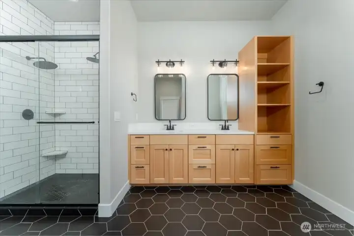 Primary bathroom with large walk-in shower, double sinks and custom cabinets.