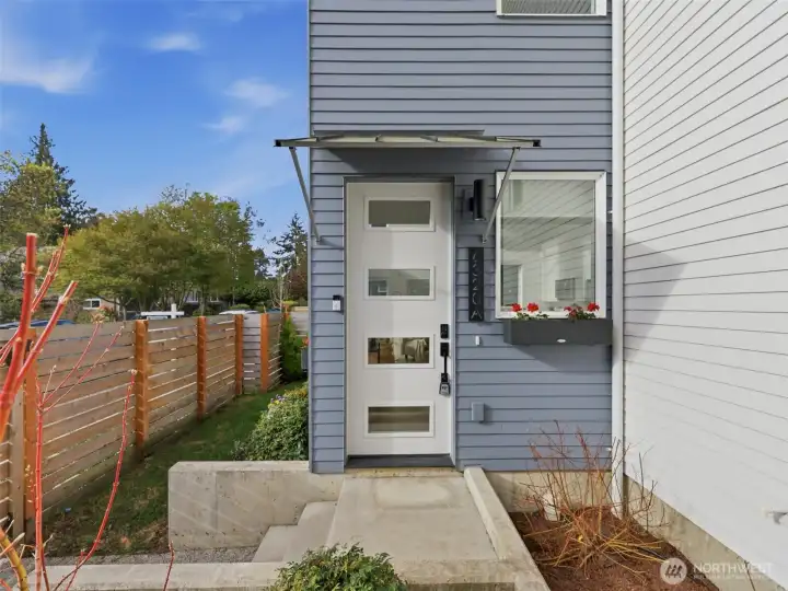Fenced yard with new awning and landscaping