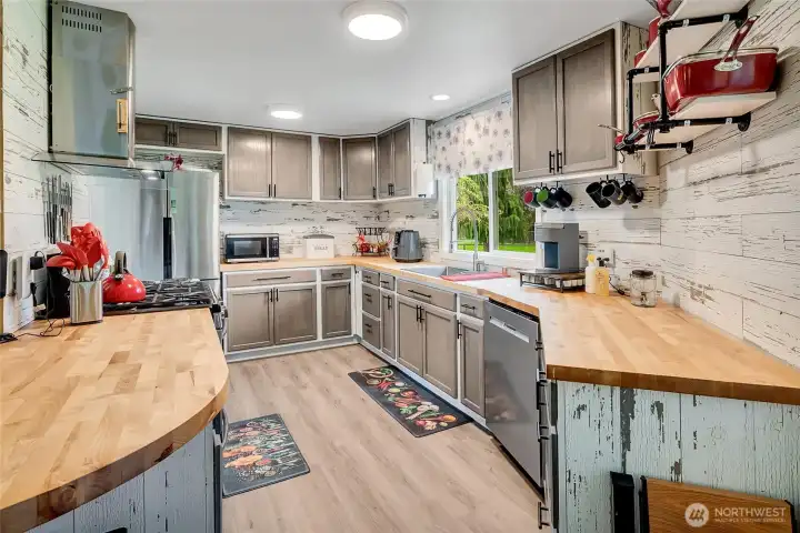 Updated kitchen with butcher block counters, great appliances, good storage, and a small eating space