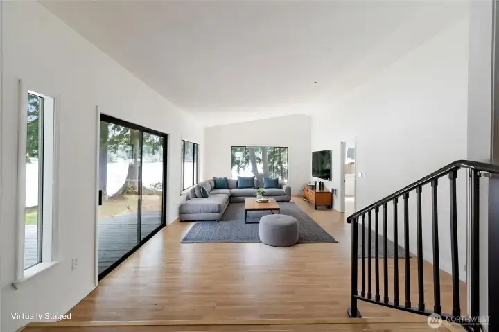 Virtually staged great room looking to the lake