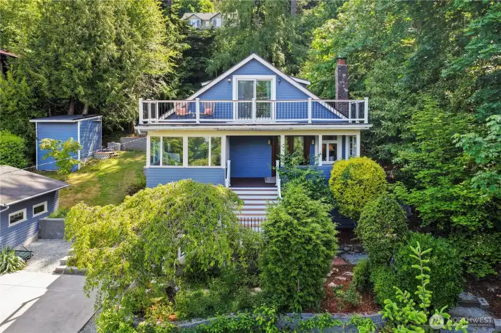 Classic Craftsman estate nestled in the heart of Three Tree Point with mature landscaping, tiered geo-shored grounds, and timeless coastal character.