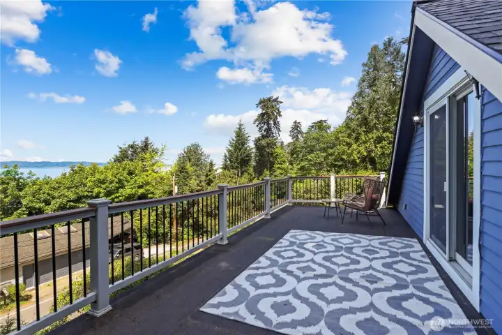 Expansive rooftop deck perfectly positioned to capture  sunsets over Vashon Island and the Olympic Mountains.