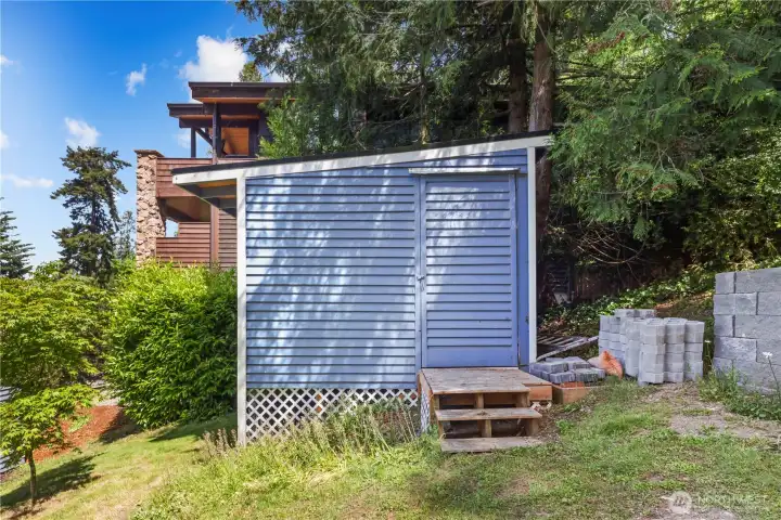 Convenient outdoor storage shed ideal for gardening tools, lawn equipment, and additional organization.