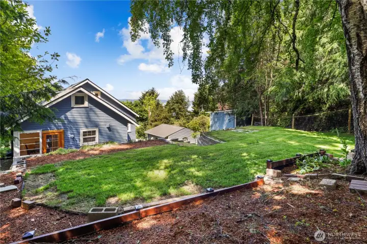 Beautiful tiered property with a lush upper grassy lawn creating additional room to relax, gather, and enjoy the outdoors.