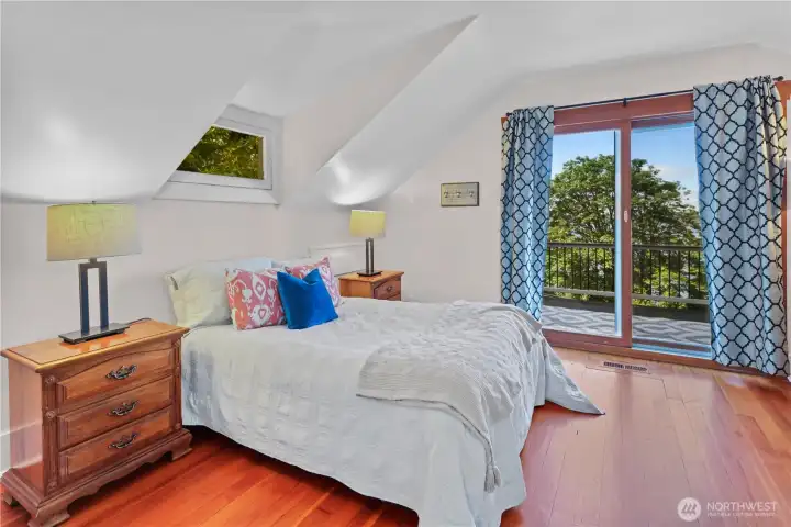 Spacious primary with access to the rooftop deck.