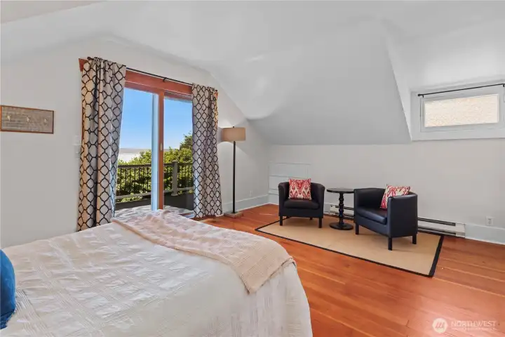 Primary bedroom with a slider to the rooftop deck.