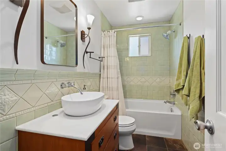 Beautifully tiled bathroom with new vanity.