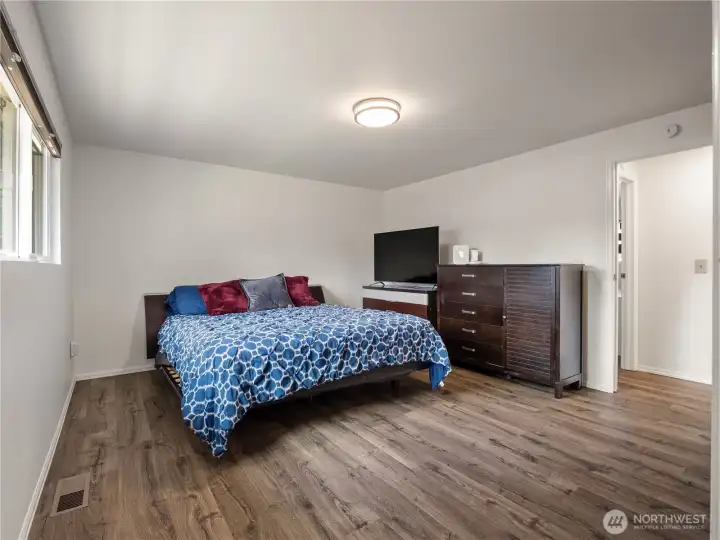 The spacious primary suite also has new flooring and a large window that overlooks the beautiful backyard. The spacious primary suite also has new flooring and a large window that overlooks the beautiful backyard.
