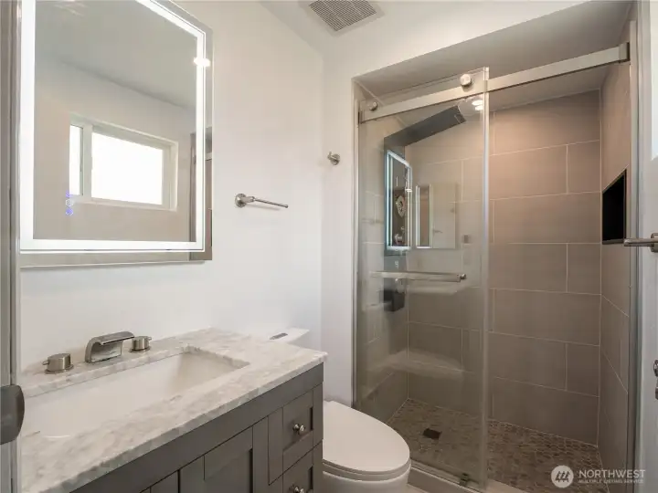 This fabulous private en suite is fully updated to include a full-tiled walk-in shower with spa-like water feature. This fabulous private en suite is fully updated to include a full-tiled walk-in shower with spa-like water feature.