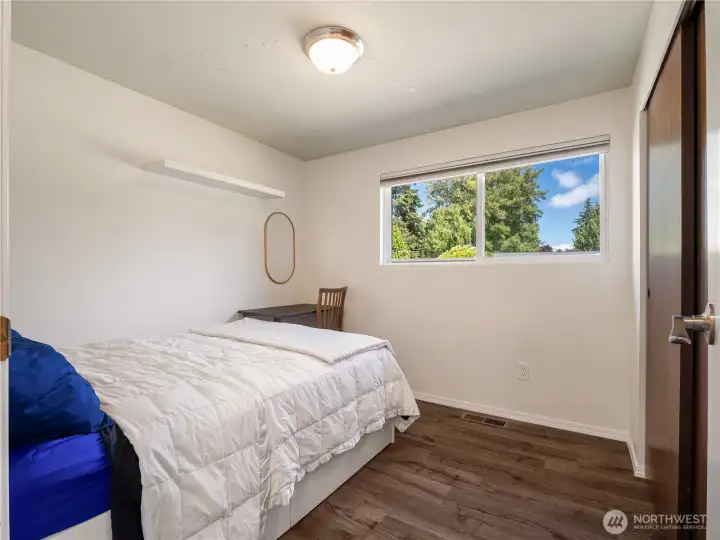 This large upper level bedroom has new flooring and large window overlooking the front yard. This large upper level bedroom has new flooring and large window overlooking the front yard.