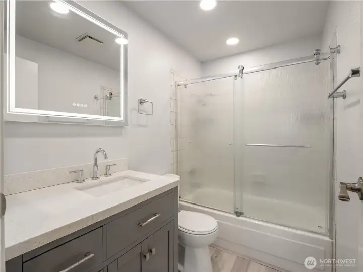 This completely updated full bathroom serves the upper-level of the home. It comes complete with a fog-free mirror with adjustable light hues. This completely updated full bathroom serves the upper-level of the home. It comes complete with a fog-free mirror with adjustable light hues.