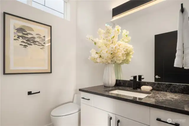 A powder room is discreetely located on the main floor and also features the same designer finishes.