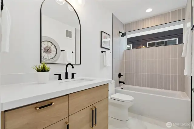 Main level full bath with tiled surround tub shower
