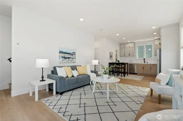 The open kitchen flows into a spacious living area, perfect for modern entertaining and relaxation.