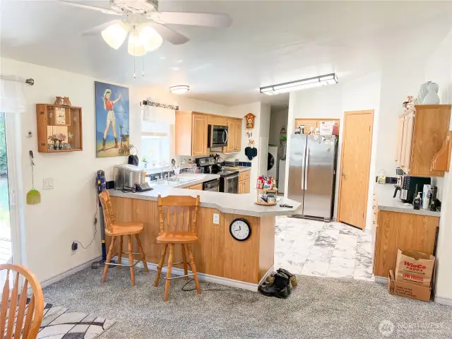 Kitchen enjoys a breakfast bar...plenty of cabinets and walk-in pantry