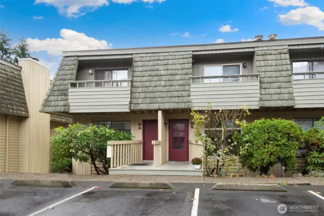 Exterior entrance with one step. Two assigned parking spaces, directly in front of home.