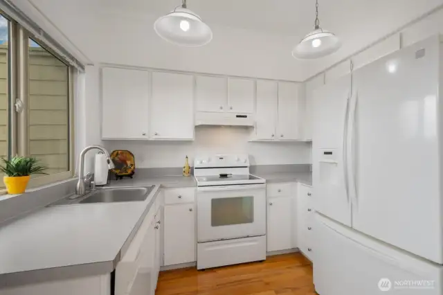 Kitchen with ample counter and cabinet space, hardwood floors. All appliances included.