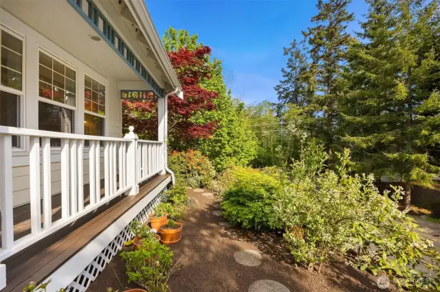 This stone path leads to a gate around the corner, connect the front of the home with the grassy back yard. All beautifully landscaped with love and care.