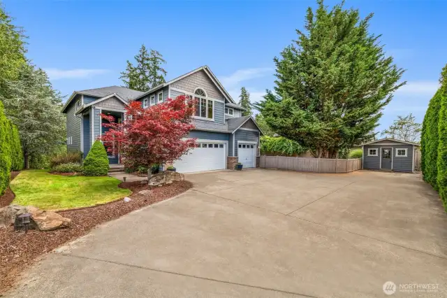 Manicured landscaping, a covered front porch, and timeless curb appeal set the tone.