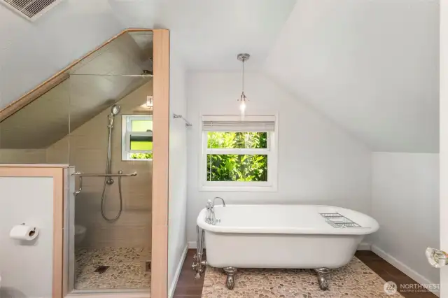 Full bath with custom tile shower and standalone claw tub.
