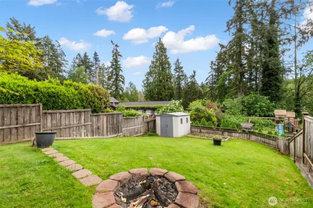 Well-kept yard with firepit.