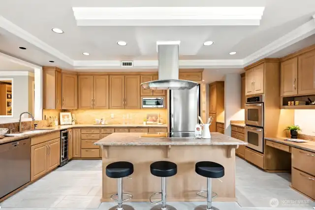 Large kitchen with induction cooktop and island seating