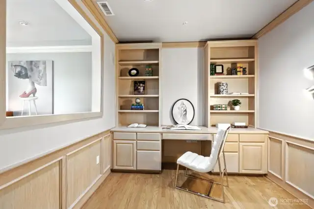 Large office featuring built-in cabinetry for efficient storage and a professional aesthetic.