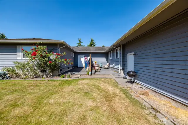 In the back yard, looking toward the patio with privacy fence separating the units.