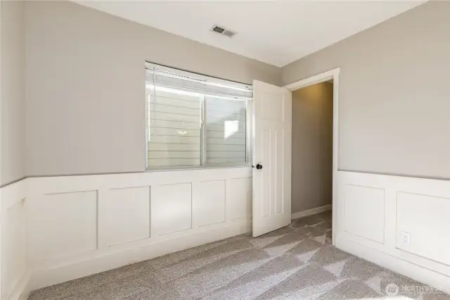 Third bedroom includes wainscoting and walk-in closet