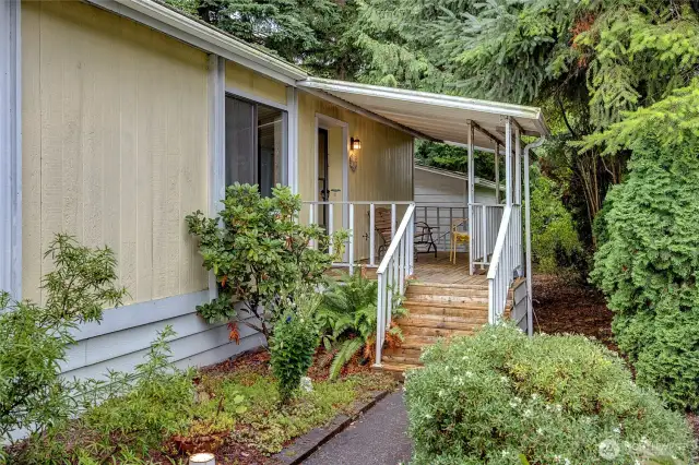 Covered front porch, steps away from the covered carports.