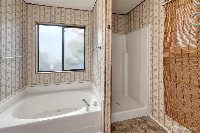 Soaking tub and shower in en-suite bath.