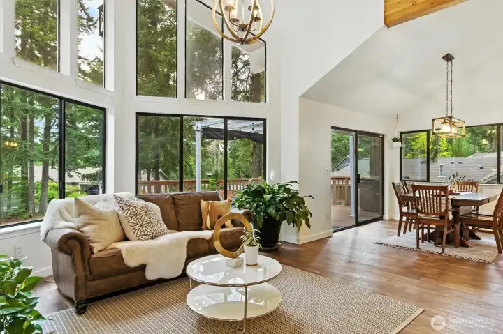 Soaring windows, vaulted ceiling, beam and beautiful LVP wood floor