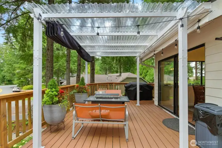 Expansive upper deck in front of home with cover from the rain