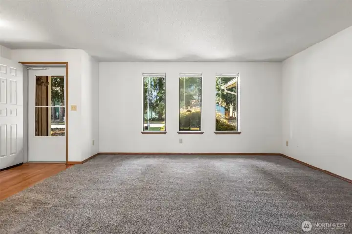 Formal living room has abundant natural light