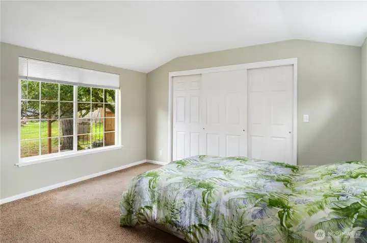 The primary bedroom features a very large walk-in closet and a large window to let in the light.