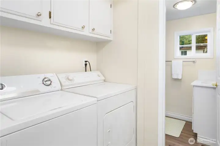 Utility room is off of the hall bathroom. It has storage above the washer and dryer.