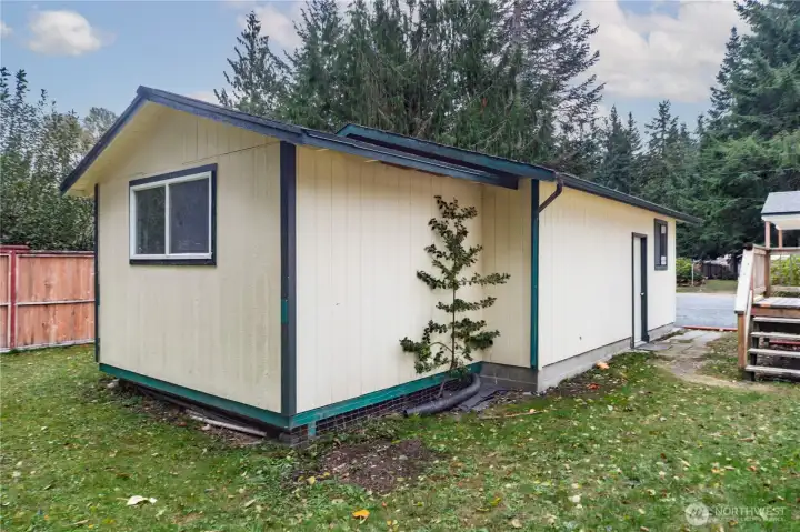 This is the outside of the shop which is in the back portion of the garage. It is large enough for woodworking, projects or storage.