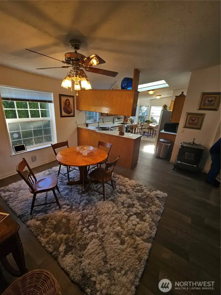 Looking from the spacious dining room to the kitchen and eating area.