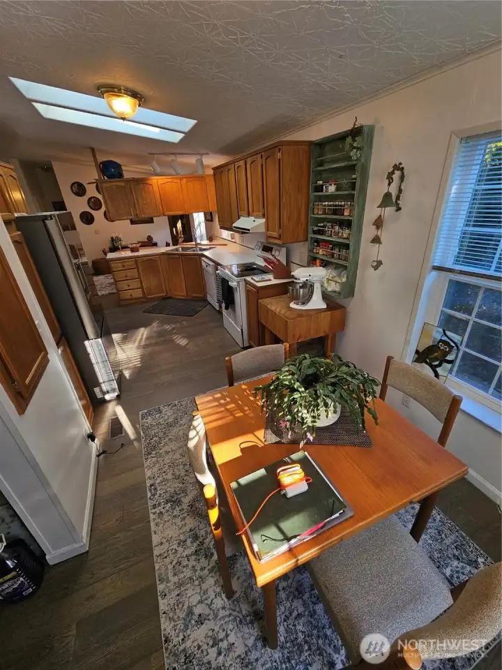 Eat-in kitchen table surrounded by light from the windows.