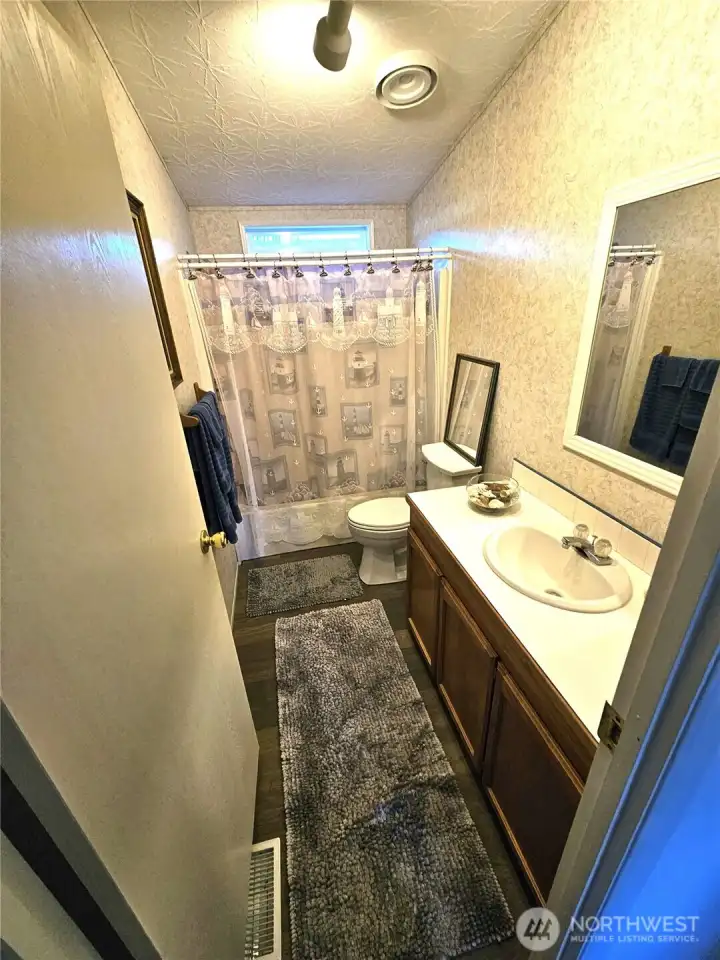 Full-sized bathroom located by bedrooms 2 and 3.