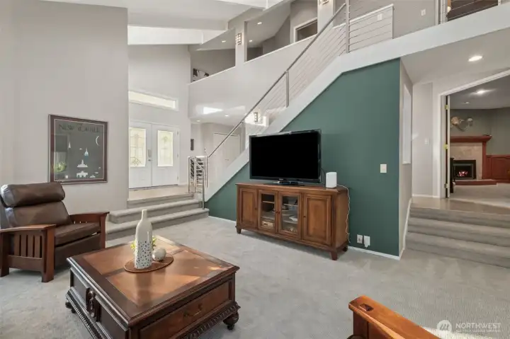 From this angle in the living room, you can see the designer cable railing system, raised ceiling, and upper level loft. The family room is steps away to the right.
