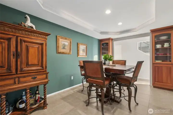 Elegant dining room boasting an octagonal tray ceiling with crown and cove lighting, perfect for gatherings.