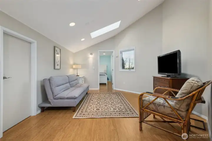 Cozy upstairs living area with comfortable seating space and natural light.