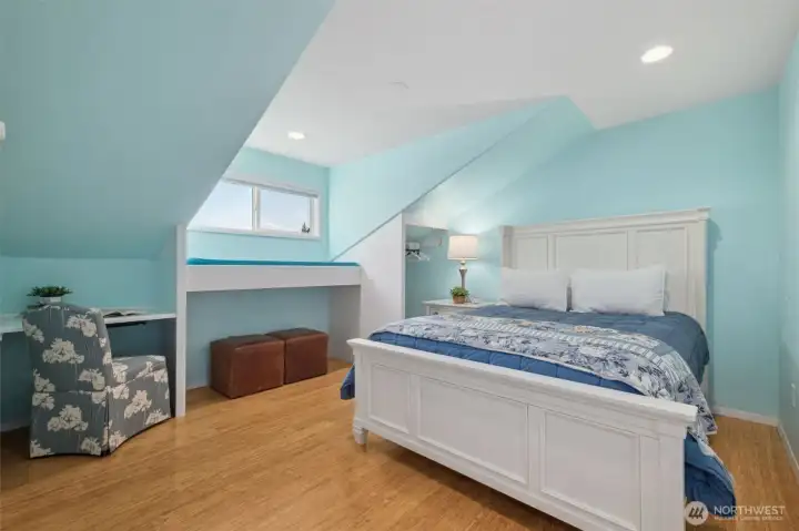 Charming bedroom with sloped ceilings and cheerful color palette.